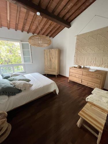 a bedroom with a large bed and a wooden table at Under the Tower in Pisa