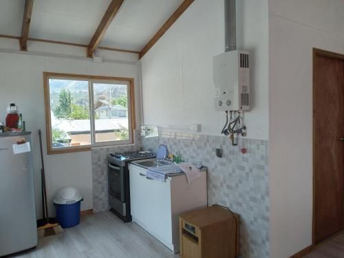 a kitchen with a stove and a refrigerator at Calfu in Chile Chico
