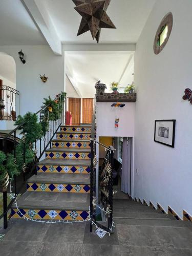 a staircase in a house with a star on the wall at Casa Lomas Grangelo in Atlixco