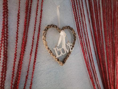 a heart shaped ornament hanging on a wall at Frasta's Rose in Plaka