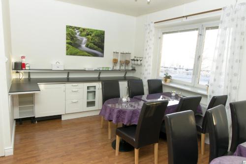 a dining room with a table and chairs at Hotell Linden in Östersund