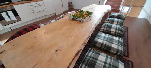 a wooden table with a bowl of fruit on top of it at Arrayanes Royal in Sierra Nevada