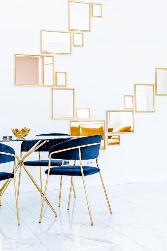 a dining room with blue chairs and a table at Thome Exclusive Cuvee Turda in Turda