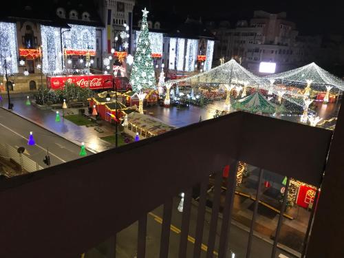 a view of a city at night with a christmas tree at Sweet cozy Ultracentral in Craiova