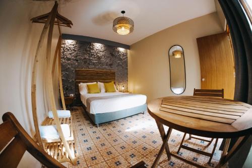 a bedroom with a bed and a table and a chair at Viajero Cartagena Hostel in Cartagena de Indias