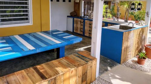 a kitchen with a blue bench and a sink at Barefoot Bonaire in Kralendijk
