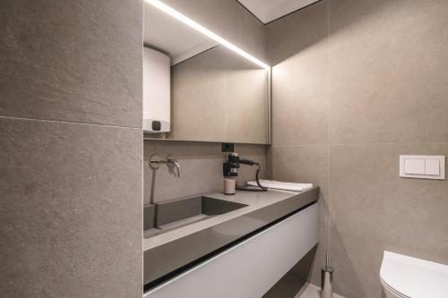 a bathroom with a sink and a toilet at Two Steps Apartments Tirana in Tirana