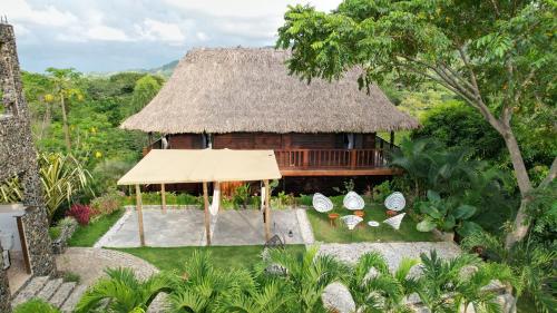 an aerial view of a house with a thatch roof at Villa Tayrona in El Zaino