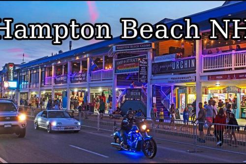 a man riding a motorcycle down a city street at night at Luxury Suite in the Heart of Hamptons South Beach! in Hampton