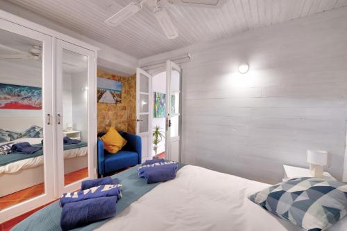 a bedroom with a large white bed with blue pillows at The Secret Corner of Luz in Luz
