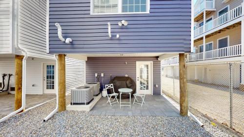 a purple house with a patio with a table and chairs at Beach House Steps away from the Boardwalk and Beach with Ocean Views in Seaside Heights! in Seaside Heights