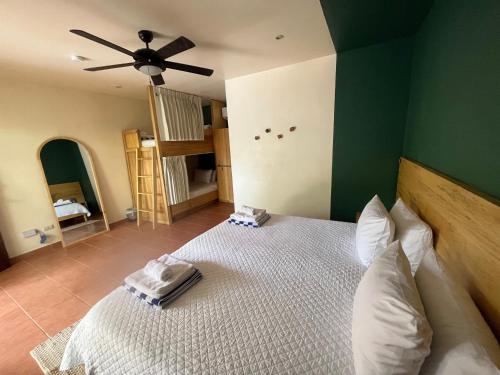 a bedroom with a large bed with a green wall at ONDA - Playa Grande - Adults Only in Playa Grande