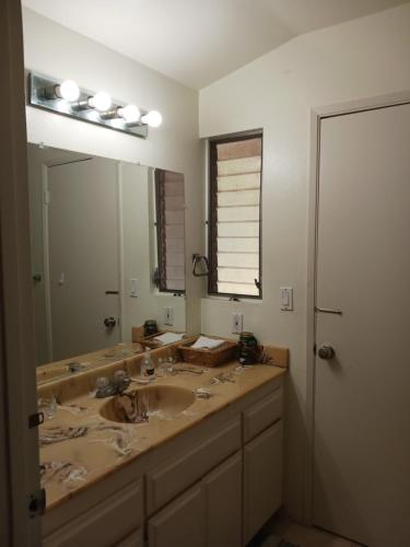 a bathroom with a sink and a large mirror at Bed and Breakfast in Hollywood Hills in Los Angeles