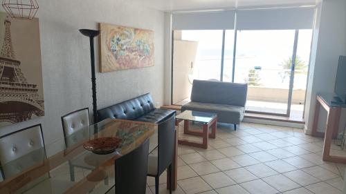 a living room with a glass table and a couch at San Alfonso del Mar Goleta 307 in San Antonio