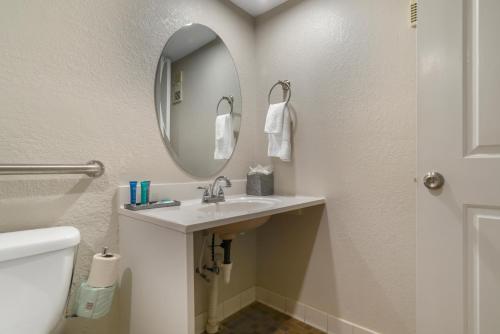 a bathroom with a sink and a mirror at Inn on Destin Harbor, an Ascend Collection Hotel in Destin
