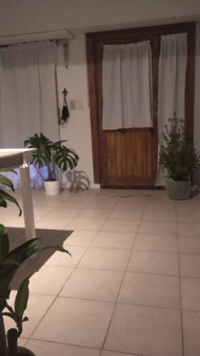 a room with a wooden door and potted plants at 3 Ambientes Mar del Plata in Mar del Plata