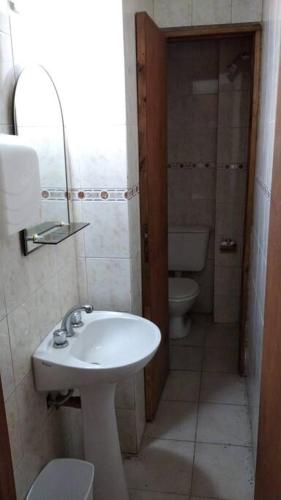 a bathroom with a white sink and a toilet at 3 Ambientes Mar del Plata in Mar del Plata