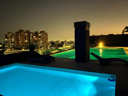 a swimming pool on the roof of a building at Dzain 1 - PISCINA -Gym- Cochera - Parrilla- Playromm- cercania Garrahan, favaloro, Britanico in Buenos Aires
