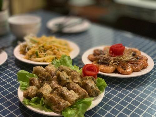 three plates of food on a blue table at Coto Center Homestay in Dao Co To