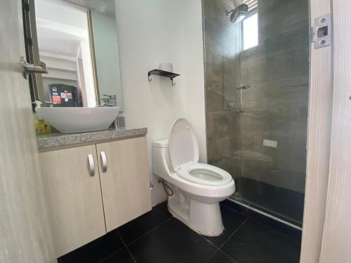 a bathroom with a toilet and a sink and a shower at CASA VIA EL PEÑON in Girardot