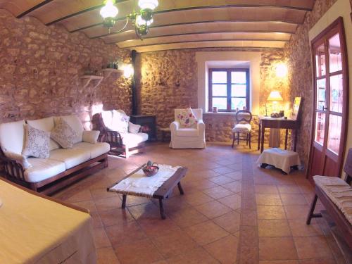 a living room with couches and a table at Ca'n Fosquet in Llucmajor