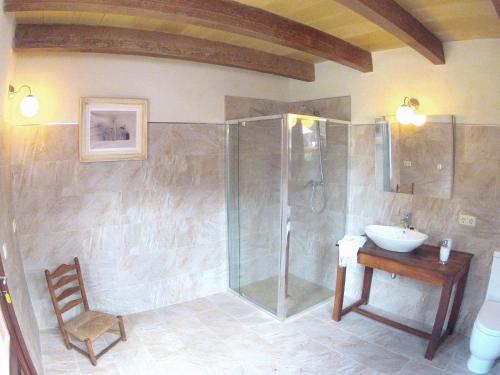 a bathroom with a glass shower and a sink at Ca'n Fosquet in Llucmajor