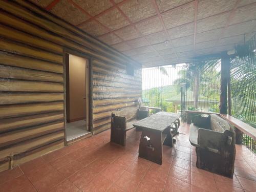 a room with a table and chairs and a wall at La Virginia Leisure Park and Amusement in Mataasnakahoy