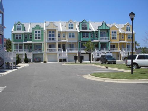 a parking lot in front of a row of houses at Cambridge Cove at Bermuda Bay by Kees Vacations in Kill Devil Hills