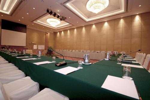 a conference room with a long table with green table cloth at Berjaya Waterfront Hotel, Johor Bahru in Johor Bahru