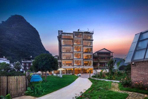 a building with a mountain in the background at Lanshan Moon Resort in Yangshuo