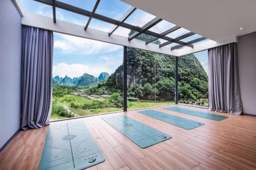 a yoga room with a view of the mountains at Lanshan Moon Resort in Yangshuo