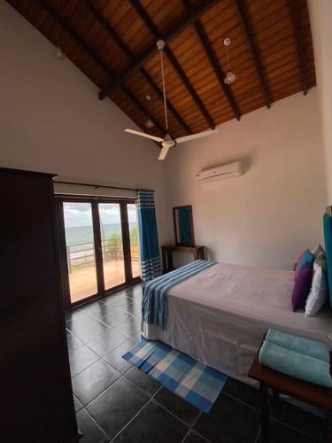 a bedroom with a bed and a view of the ocean at Reef Bungalow Private Villa, 6 bedrooms in Bopitiya