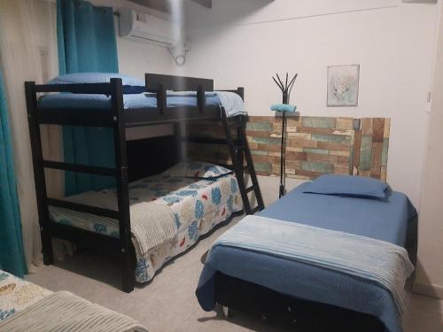 a room with two bunk beds and two trunks at Mayo´s Place in San Andrés