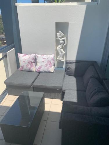 a living room with a couch and a glass table at 338 Paradiso Kingscliff Beach in Kingscliff