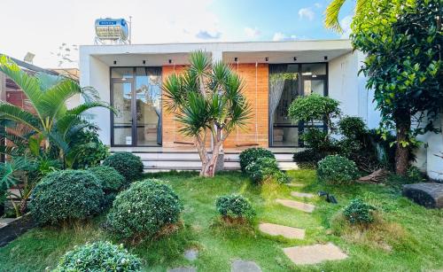 a house with a garden in front of it at The Stay Home Pleiku in Pleiku