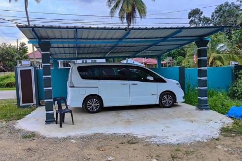 a white van parked under a blue cover at Homestay D Paya Jauh in Temerloh