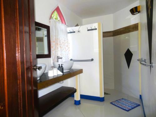 a bathroom with a sink and a shower at MG Chateau Resort in El Nido