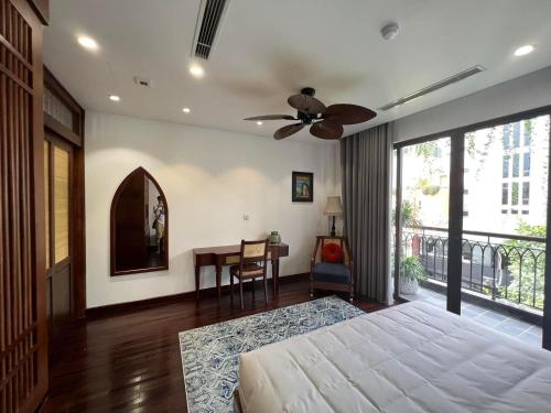 a bedroom with a bed and a ceiling fan at Camellia Residence Hanoi in Hanoi