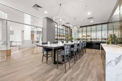 a dining room with a long table and chairs at Crowne Plaza Surfers Paradise, an IHG Hotel in Gold Coast
