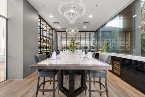 a dining room with a large table and chairs at Crowne Plaza Surfers Paradise by IHG in Gold Coast