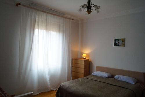 a bedroom with a bed and a large window at Appartamento Mirandola in Mirandola