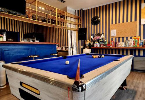 a pool table sitting in a room with at Happy Station Bangkok in Bangkok