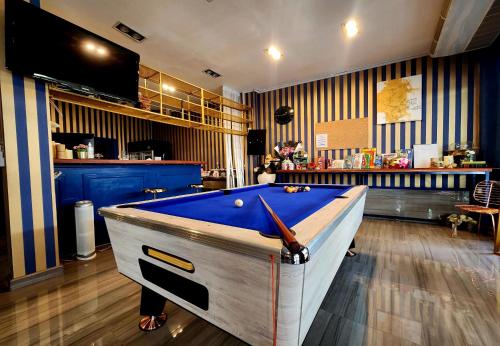 a pool table in the middle of a room at Happy Station Bangkok in Bangkok