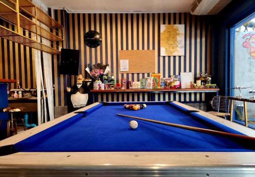 a woman standing in front of a pool table at Happy Station Bangkok in Bangkok