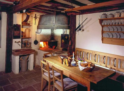 a kitchen with a wooden table and an oven at Landgasthof Zum Weissen Schwanen in Braubach
