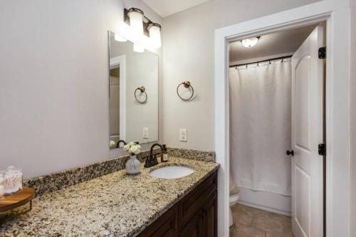 a bathroom with a sink and a mirror at Meet Me in Athens I Beautiful 4-Bdrm House I 1 Mile to DT and Mins to UGA in Athens