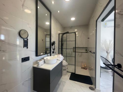 a bathroom with a sink and a shower at VILLA KARLA in Playa Blanca