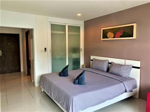 Ένα ή περισσότερα κρεβάτια σε δωμάτιο στο Pixel Condo - Panwa Beach