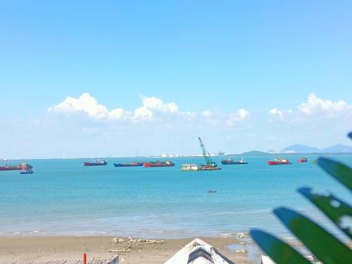 a group of boats in the water on a beach at Ann Homestay Vũng Tàu in Vung Tau
