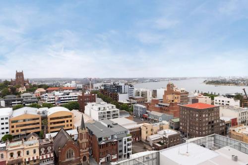 an aerial view of a city with buildings at Sunset on the Esplanade in Newcastle